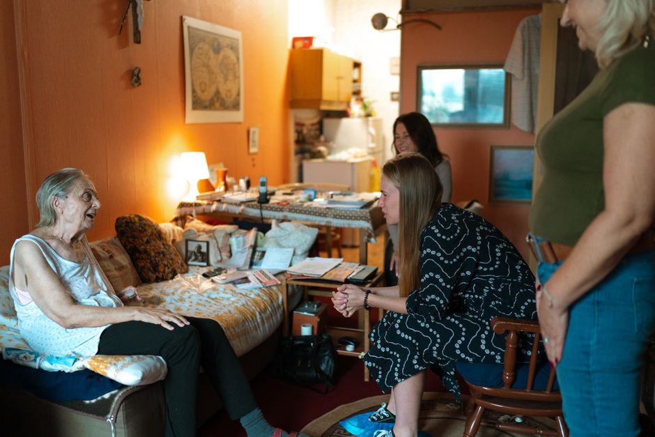 A heartwarming moment between family members in a cozy living room setting, showcasing intergenerational bonding.